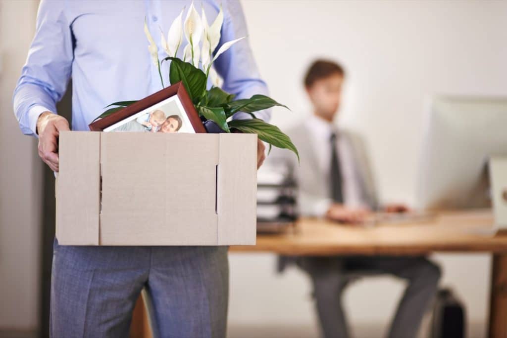 Cropped shot of a businessman leaving work as hes being replaced by a new employee.